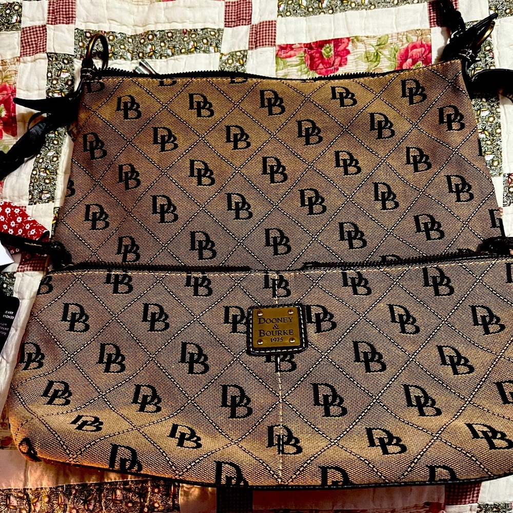 Dooney Burke purse. Does not have a strap as it frayed lined in red